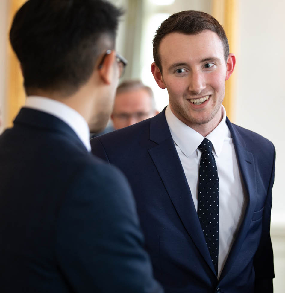 Two men talking to one another at an event